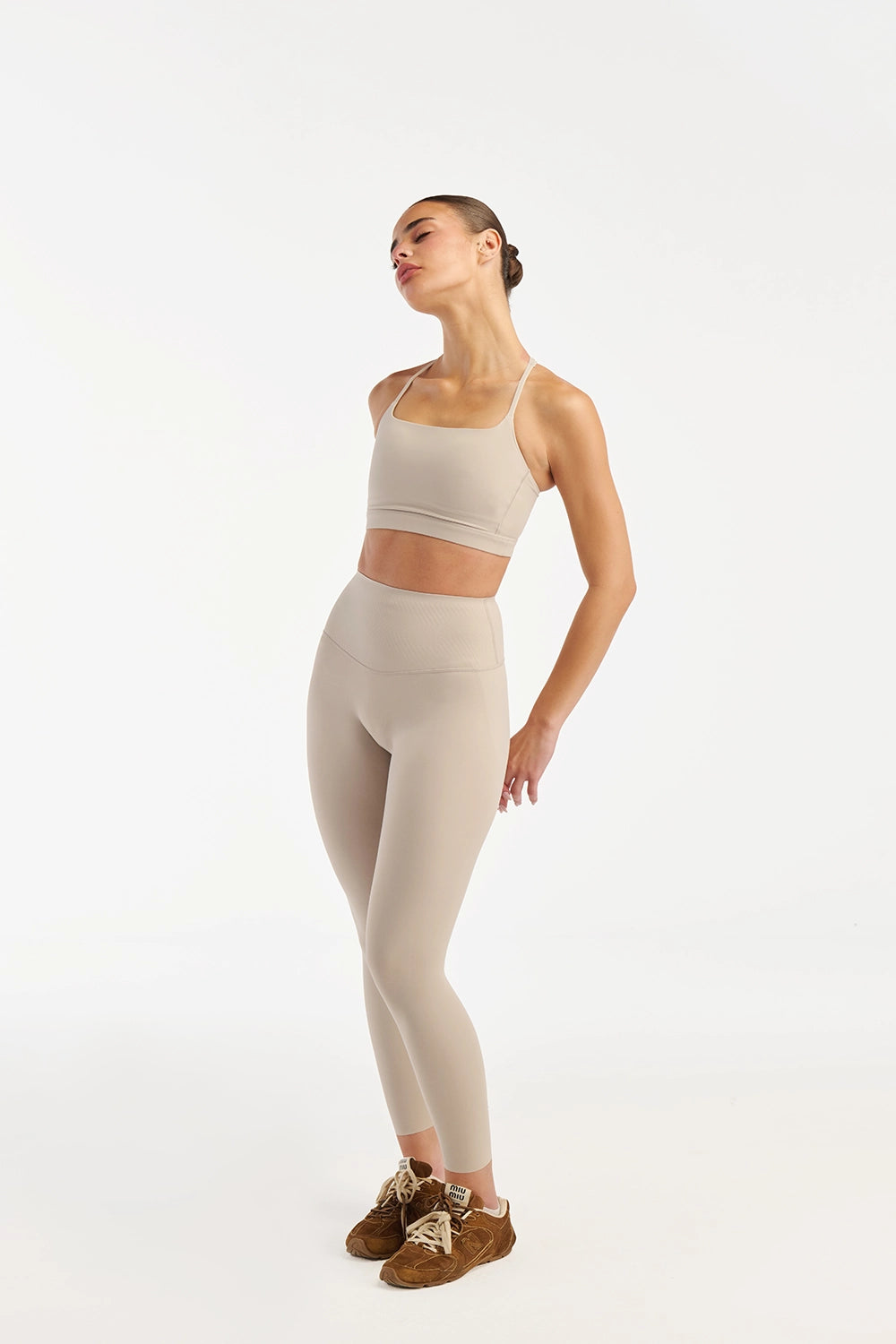 Cream activewear set women movement shot lifestyle premium - UNIX | طقم أكتيف وير كريمي نسائي لقطة ديناميكية لايف ستايل فاخر - UNIX