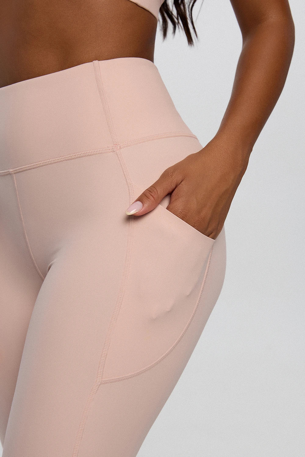 Curve Enhance pocket leggings women whip pink styled gym look - UNIX | إطلالة رياضية نسائية بتايت وردي بجيوب للجيم والمشي — UNIX