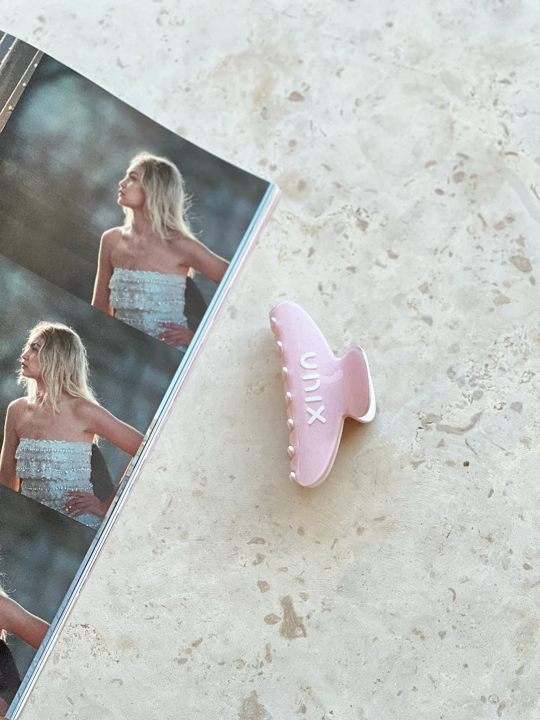 Pink hair clip detail close up sleek practical accessory women - UNIX | تفاصيل مشبك شعر بينك لقطة قريبة إكسسوار عملي وأنيق للنساء - UNIX