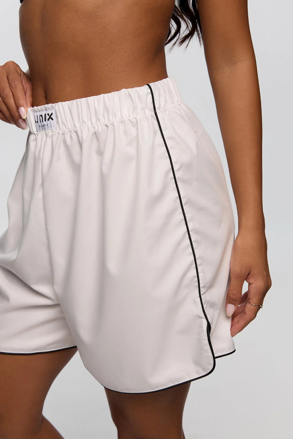 Soft white shorts women detail pocket close up minimalist design - UNIX | تفاصيل جيب شورت نسائي أبيض ناعم لقطة قريبة بتصميم بسيط - UNIX